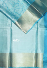 Sky Melody Blue - Ahaana -  Nita Ambani inspired semi silk with floral emboss weaving plain border