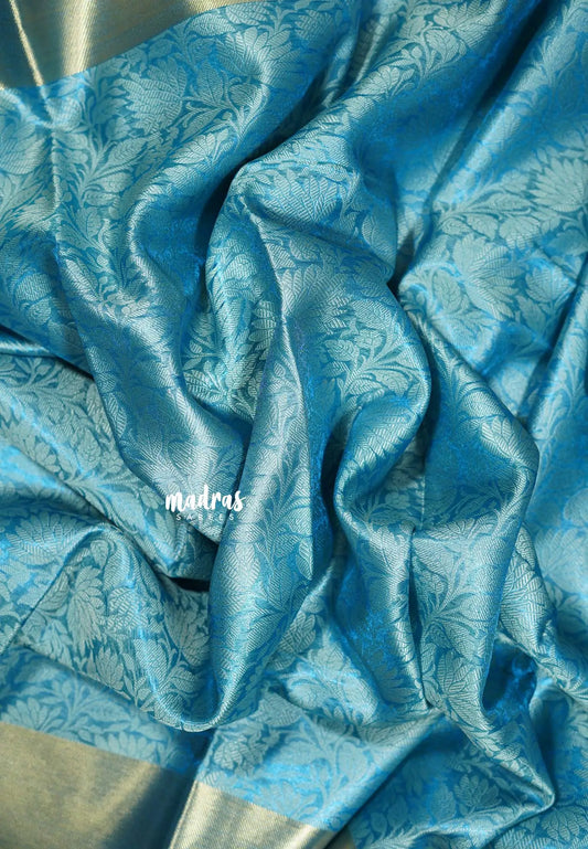 Sky Melody Blue - Ahaana -  Nita Ambani inspired semi silk with floral emboss weaving plain border